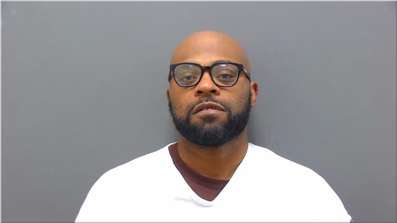 Mugshot of Powell, Cameo